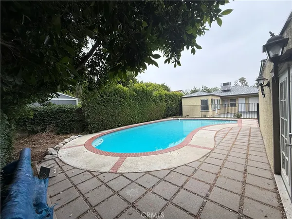 a view of a swimming pool with a patio