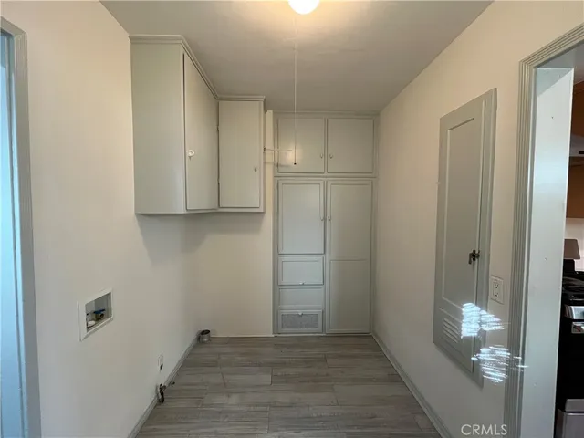 a view of hallway with wooden floor