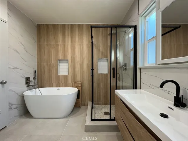 a spacious bathroom with a bathtub and shower