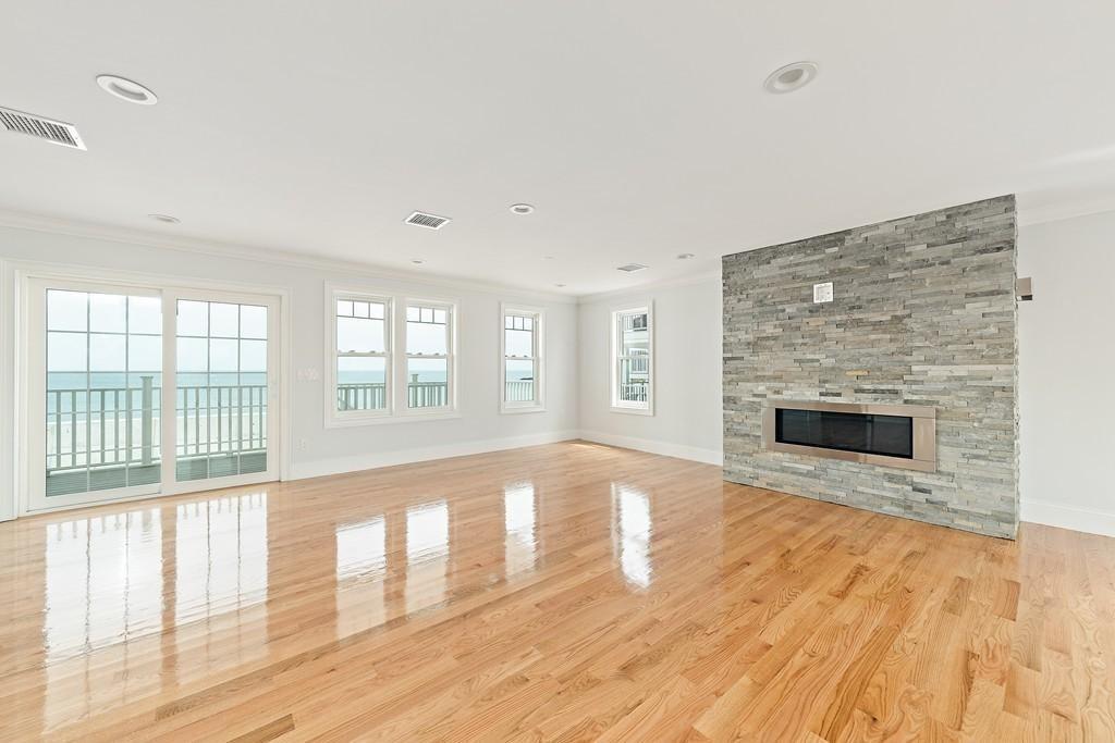 308 Ocean Street Marshfield, MA 02050 - Photo 14 of 42 wooden floor fireplace and windows in an empty room