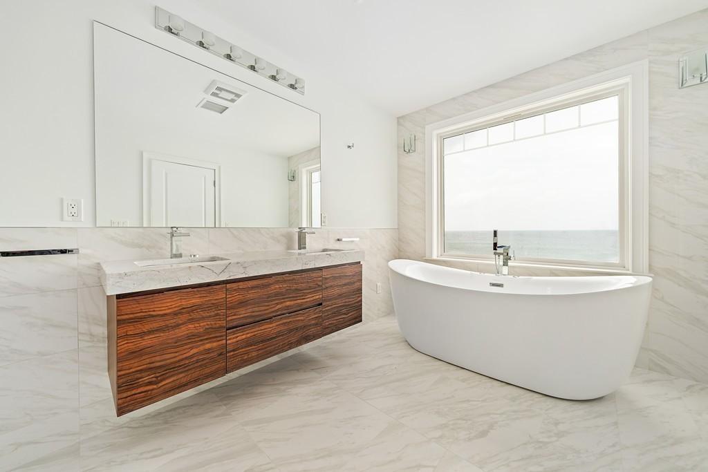 308 Ocean Street Marshfield, MA 02050 - Photo 22 of 42 a bathroom with a bathtub and double vanity