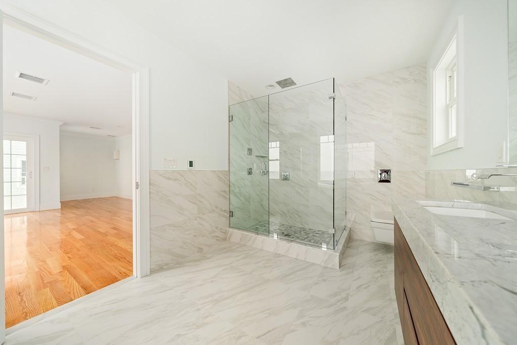 308 Ocean Street Marshfield, MA 02050 - Photo 25 of 42 a bathroom with a granite countertop sink a toilet and shower