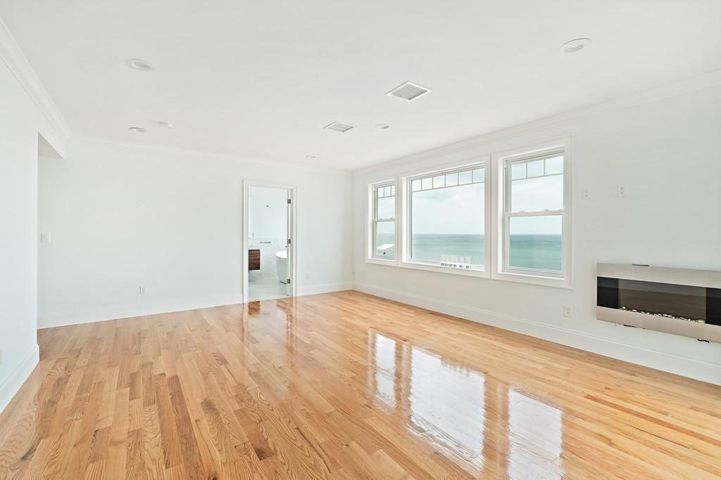 308 Ocean Street Marshfield, MA 02050 - Photo 28 of 42 a view of an empty room with wooden floor and a window