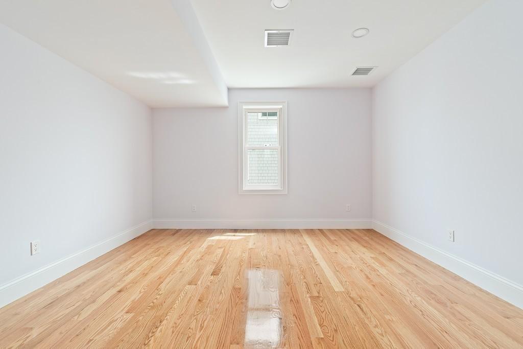 308 Ocean Street Marshfield, MA 02050 - Photo 30 of 42 an empty room with wooden floor and windows