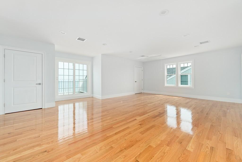 308 Ocean Street Marshfield, MA 02050 - Photo 33 of 42 an empty room with wooden floor and windows