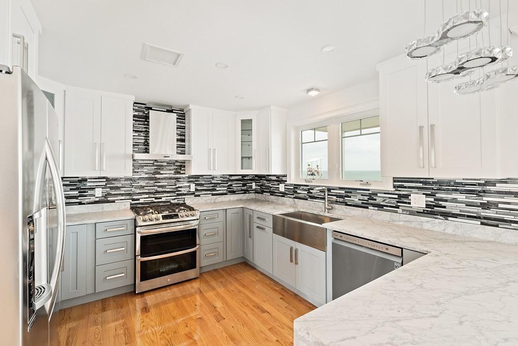 308 Ocean Street Marshfield, MA 02050 - Photo 6 of 42 a kitchen with stainless steel appliances granite countertop a stove and a sink