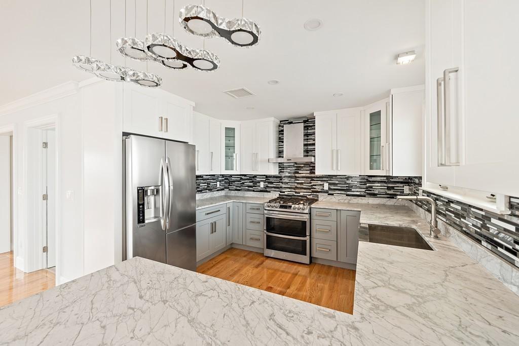 308 Ocean Street Marshfield, MA 02050 - Photo 7 of 42 a large kitchen with a stove a refrigerator and a sink