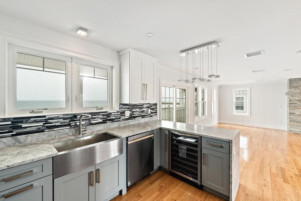 308 Ocean Street Marshfield, MA 02050 - Photo 8 of 42 a kitchen with stainless steel appliances granite countertop a stove and a sink