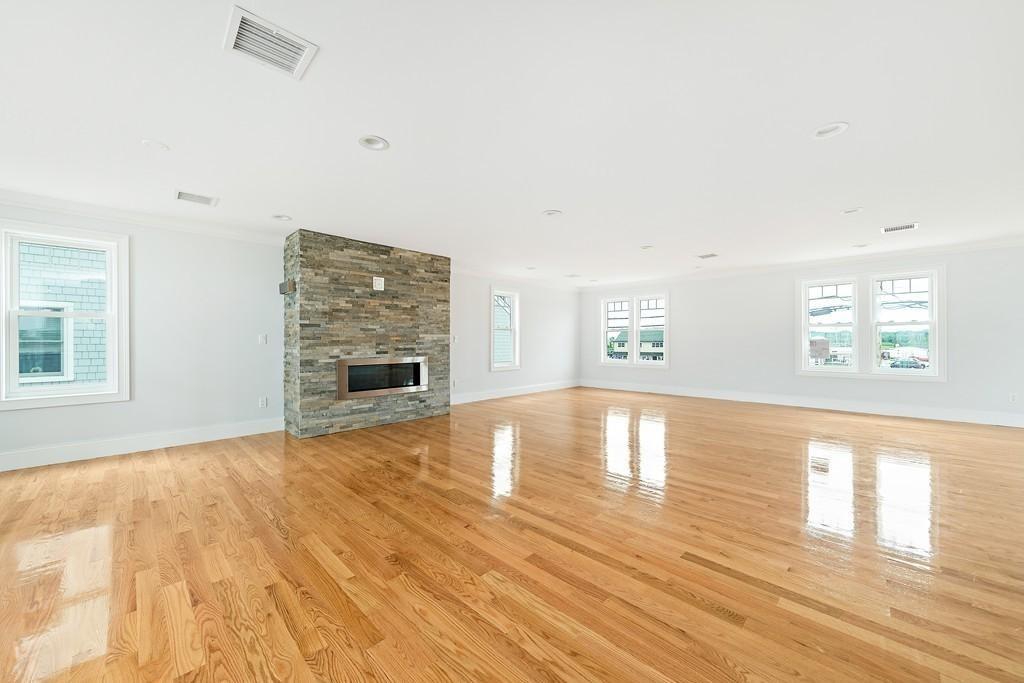 308 Ocean Street Marshfield, MA 02050 - Photo 9 of 42 a view of empty room with a fireplace and wooden floor