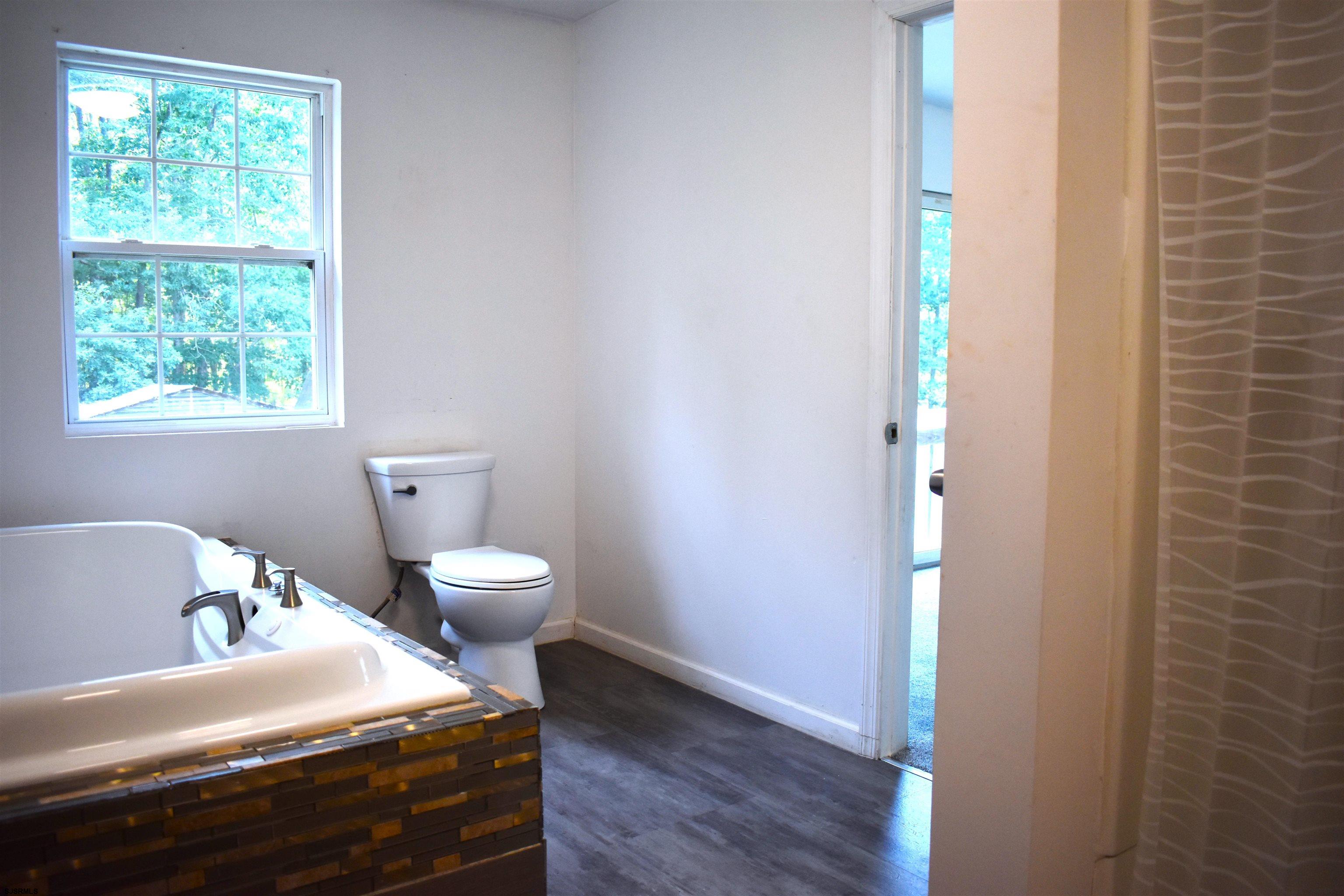 720 6th Road Newtonville, NJ 08346 - Photo 13 of 23 a bedroom with a bed and a window