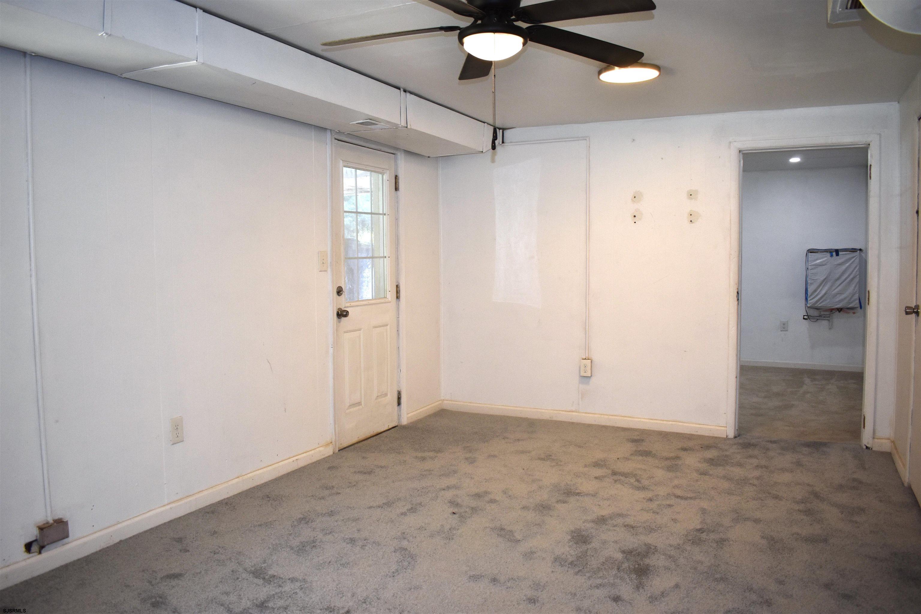 720 6th Road Newtonville, NJ 08346 - Photo 20 of 23 an empty room with an entryway and fan