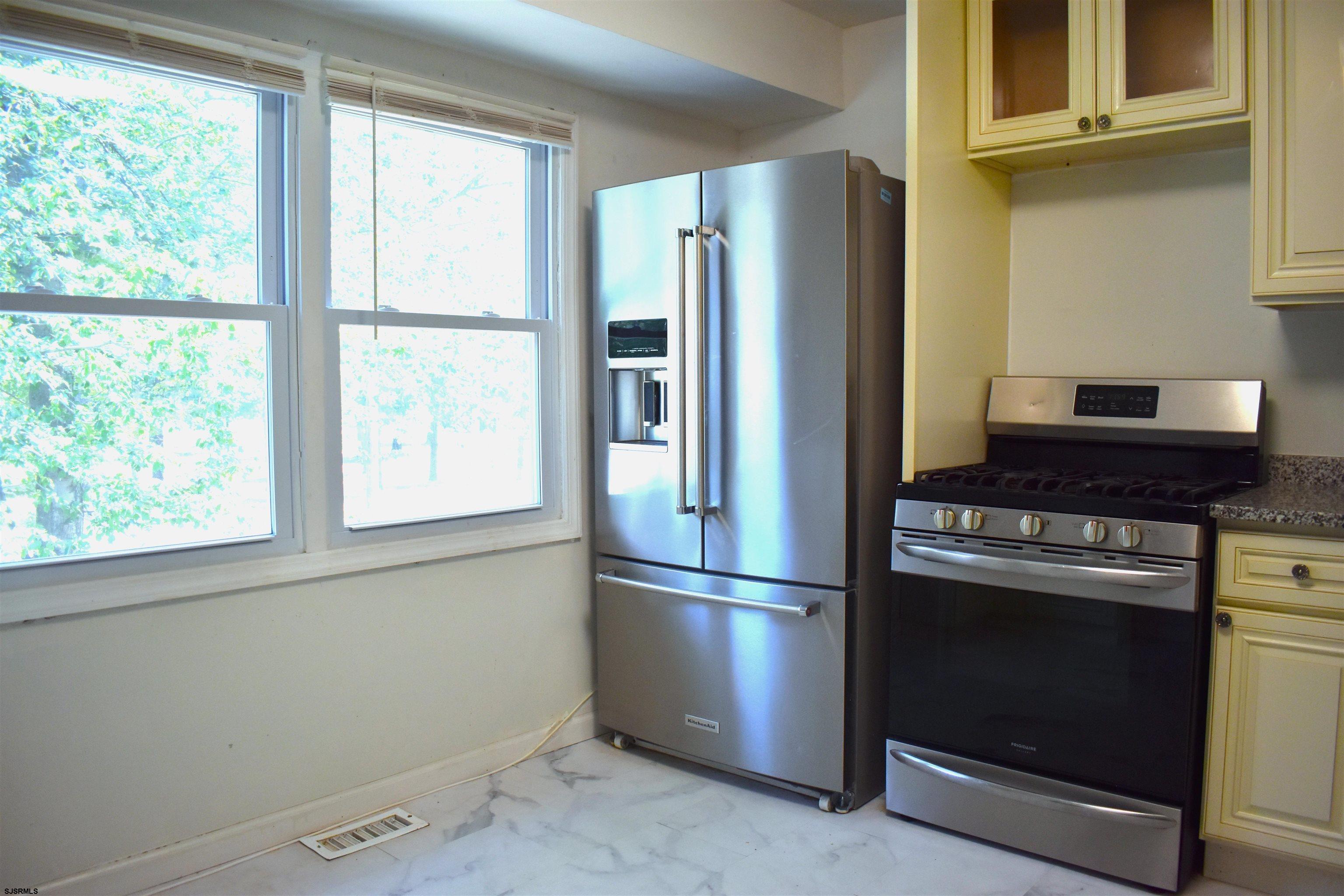720 6th Road Newtonville, NJ 08346 - Photo 4 of 23 a kitchen with stainless steel appliances granite countertop a refrigerator and a window