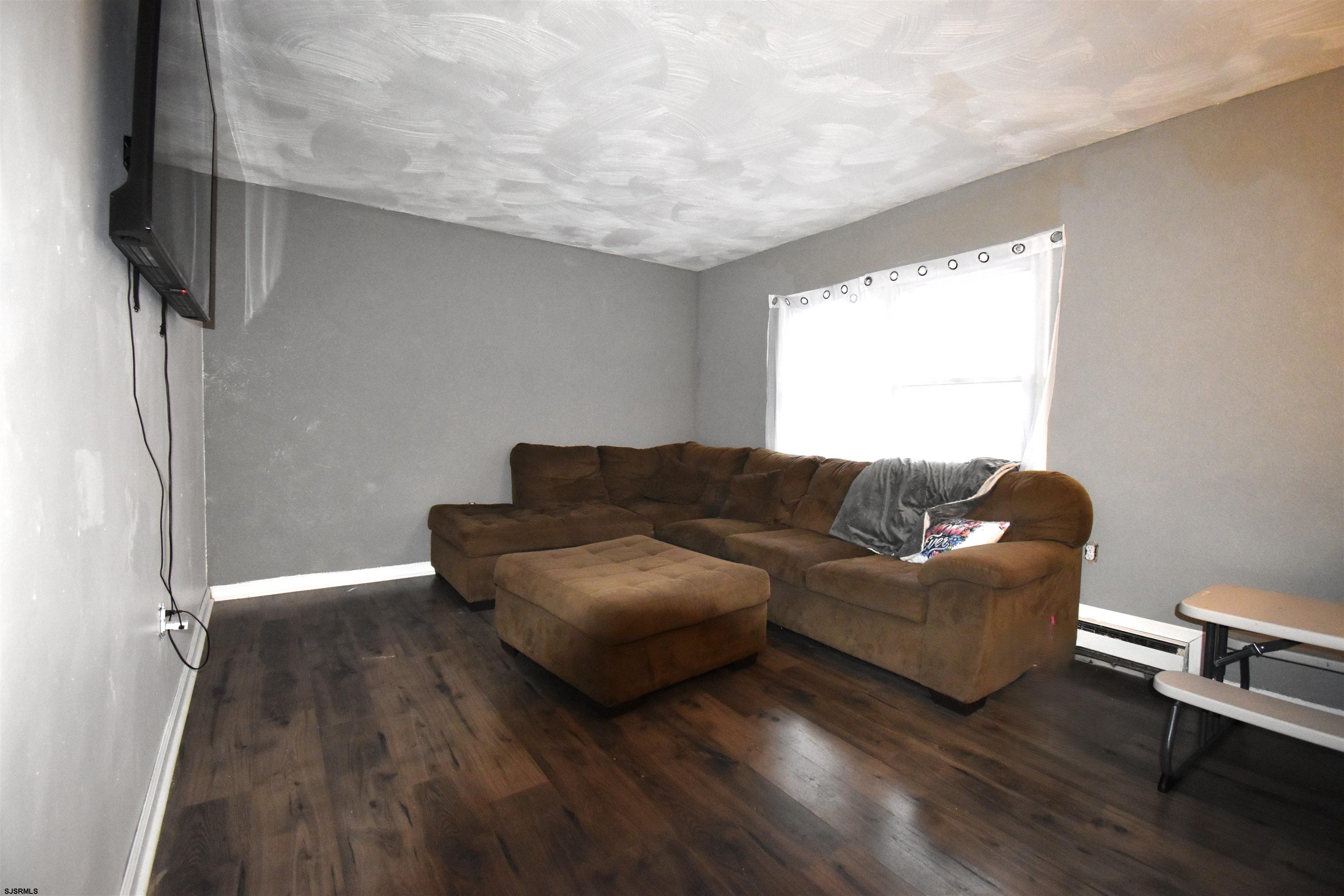 720 6th Road Newtonville, NJ 08346 - Photo 6 of 23 a living room with couches and a flat screen tv with wooden floor