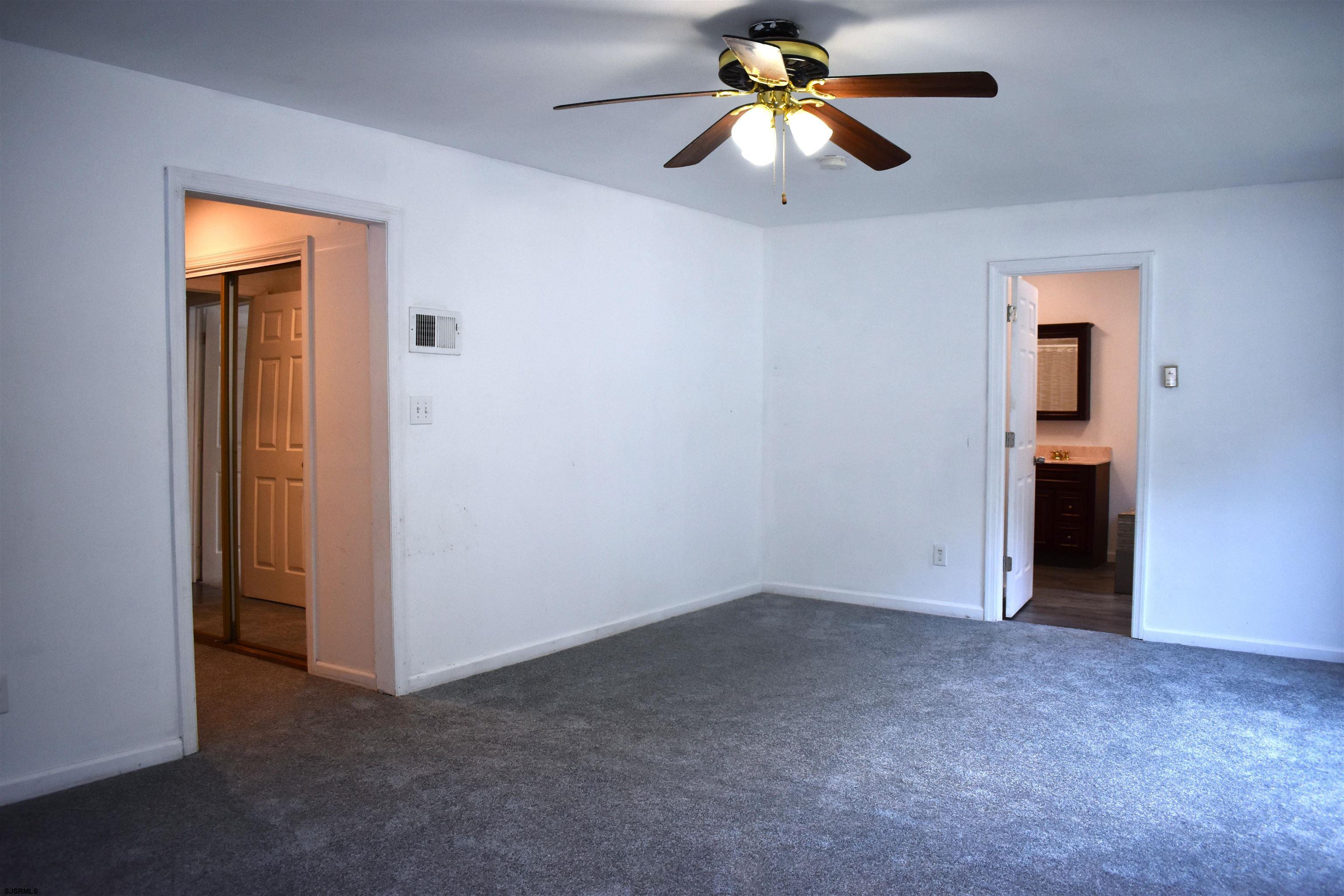 720 6th Road Newtonville, NJ 08346 - Photo 10 of 23 an empty room and chandelier fan