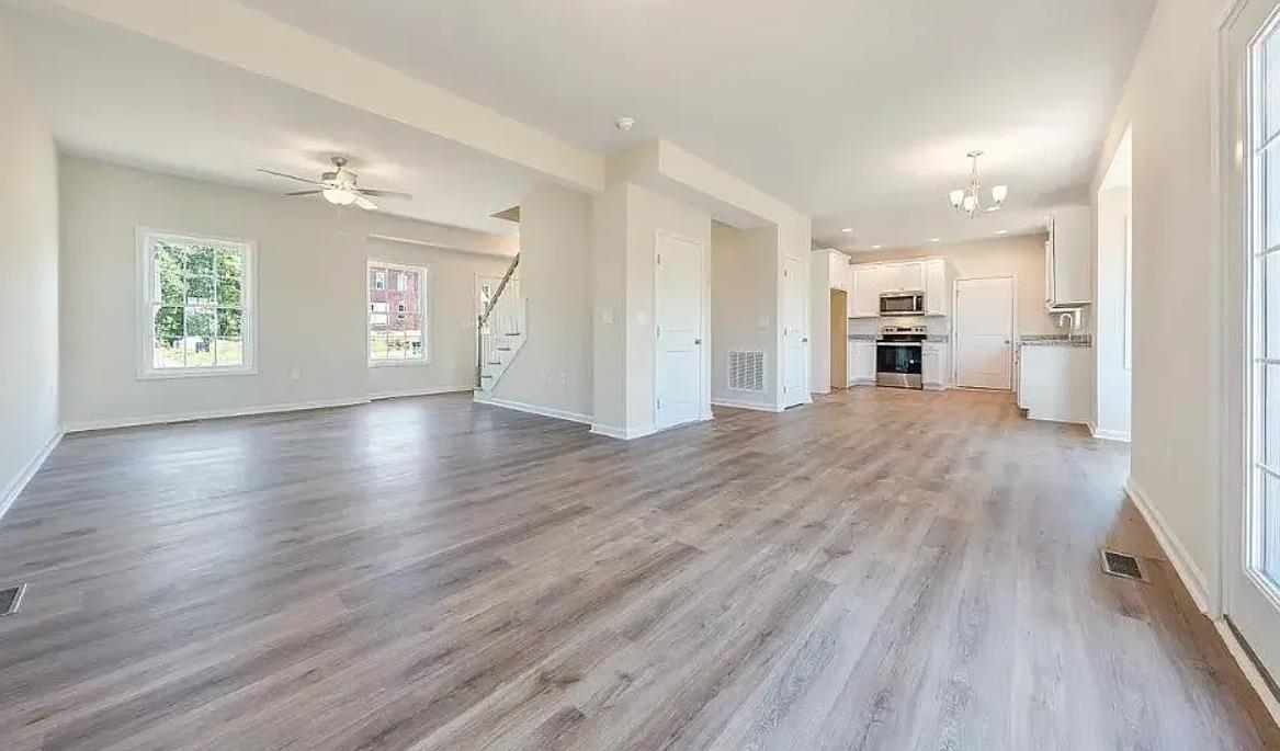 201 Winnbrook Street Staunton, VA 24401 - Photo 4 of 12 a view of empty room with wooden floor and window