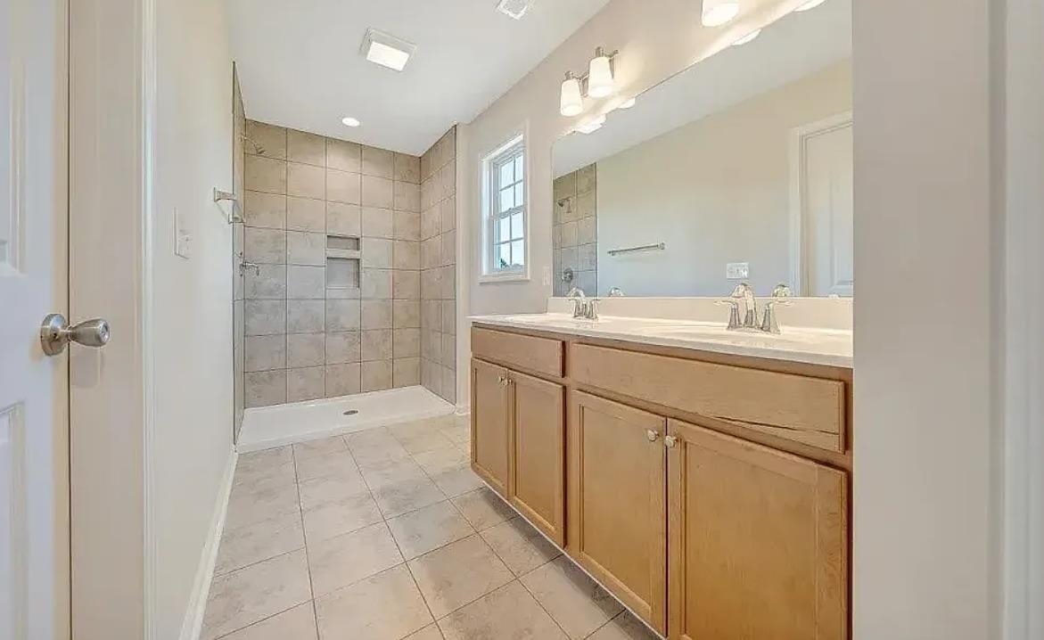201 Winnbrook Street Staunton, VA 24401 - Photo 8 of 12 a spacious bathroom with a shower sink and mirror