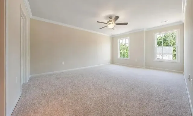 a view of a livingroom with a ceiling fan and window