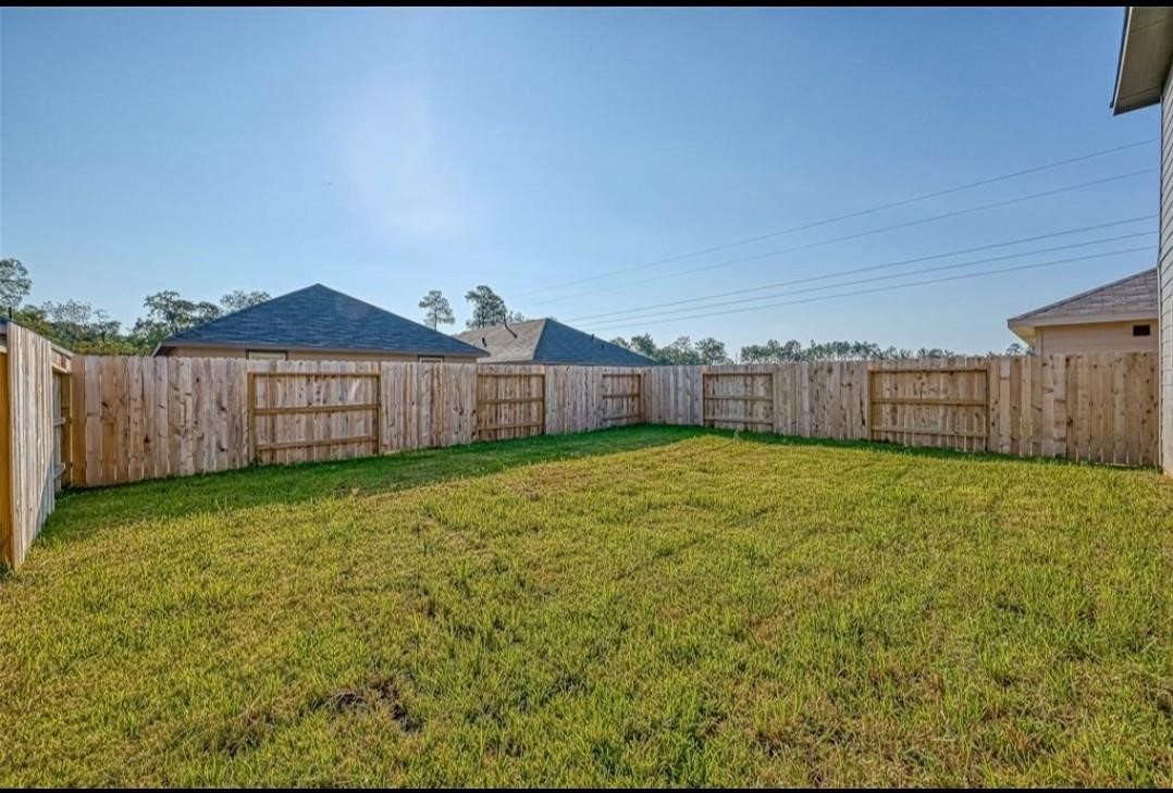 1319 Vincente Court Conroe, TX 77301 - Photo 10 of 10 a view of a backyard with a garden