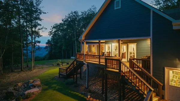 a view of a porch with furniture and garden