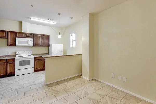 an empty room with a chandelier fan