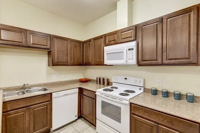 a kitchen with stainless steel appliances granite countertop a sink stove and cabinets