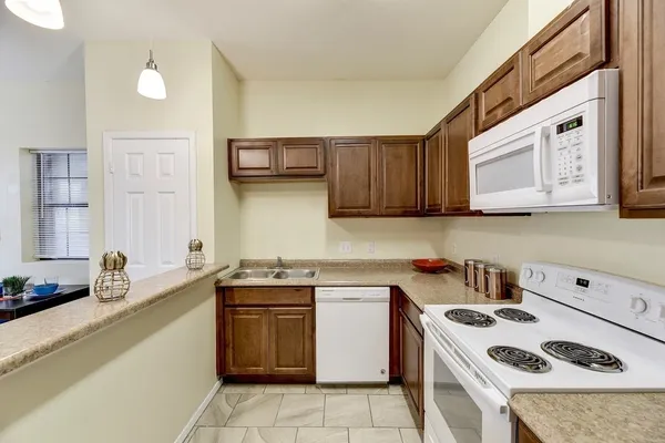 a kitchen with a sink a stove and cabinets