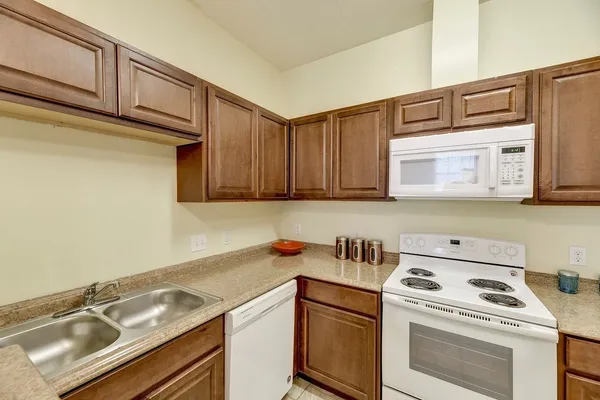 a view of a kitchen with sink washer and dryer