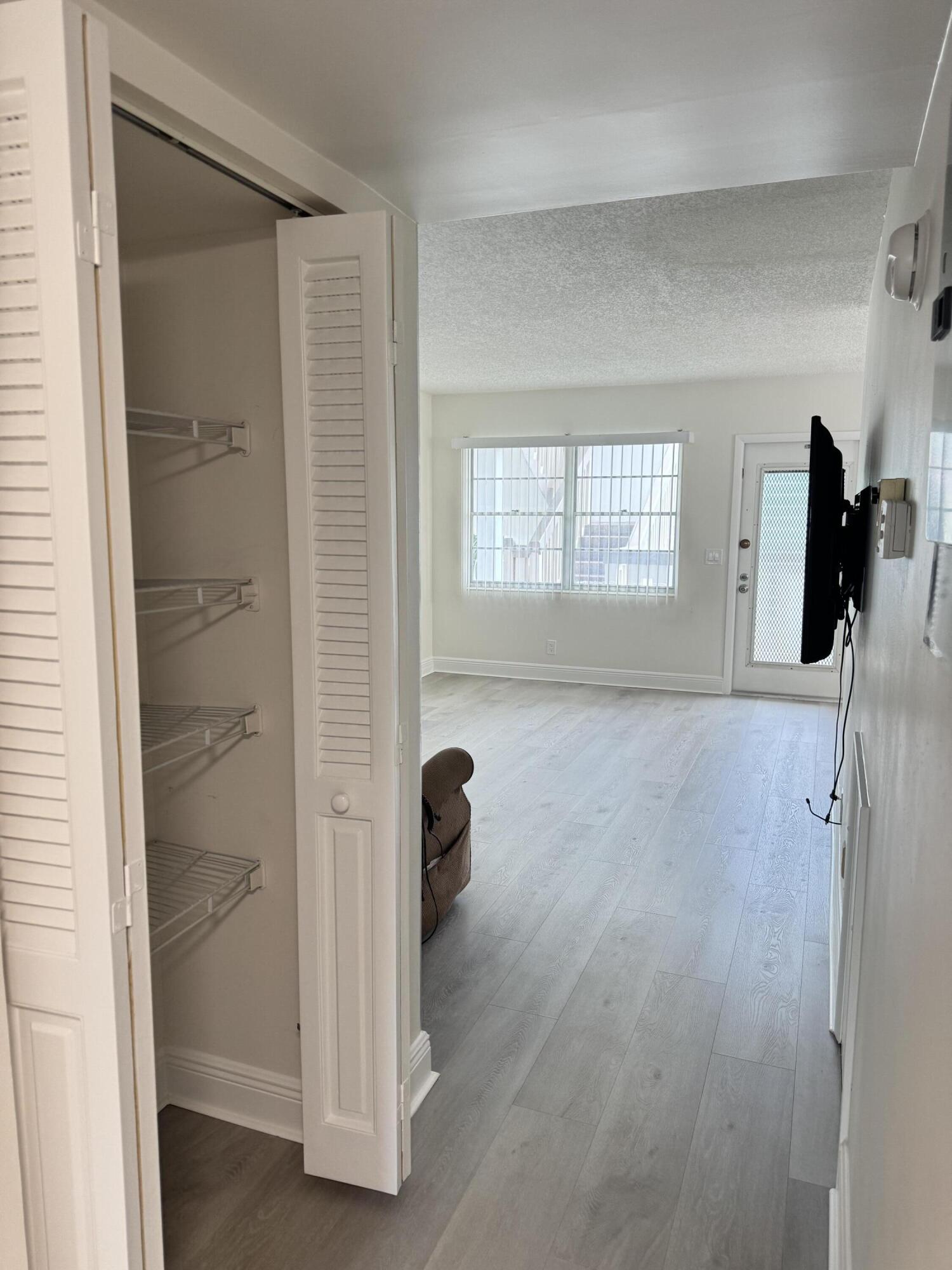 2039 Rexford A, Unit C Boca Raton, FL 33434 - Photo 5 of 27 closet in hallway