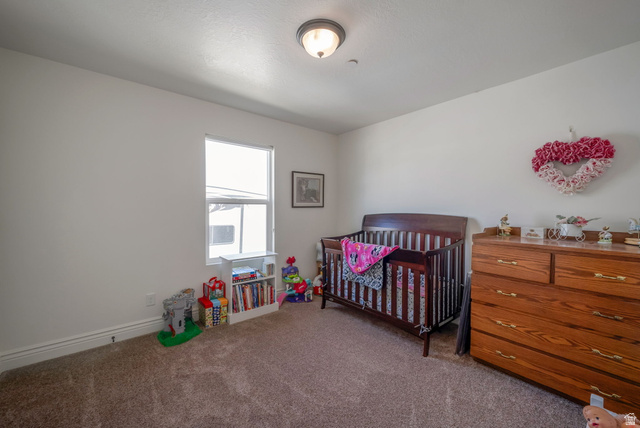 1288 North Horizon View Loop Elk Ridge, UT 84651 - Photo 25 of 40 Carpeted bedroom featuring a crib and baseboards