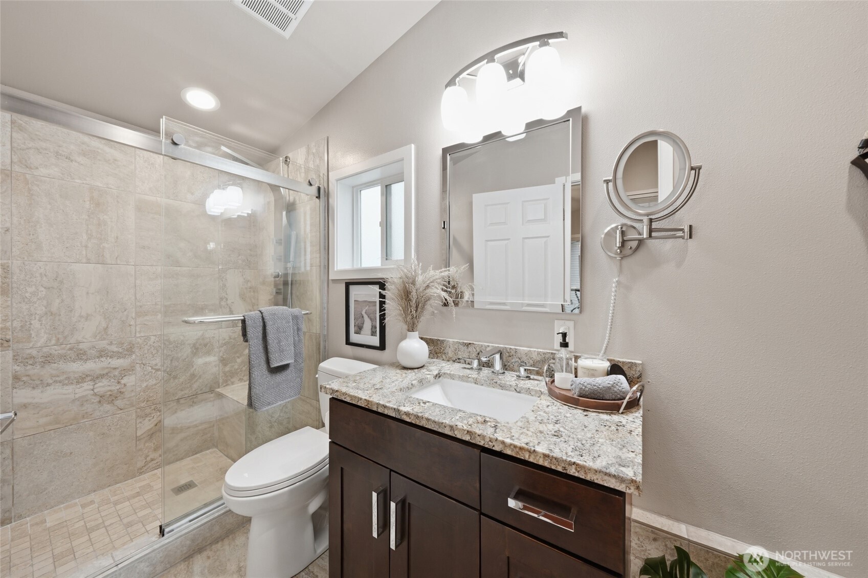 1425 Jones Avenue Northeast Renton, WA 98056 - Photo 18 of 36 a bathroom with a granite countertop toilet sink and a mirror