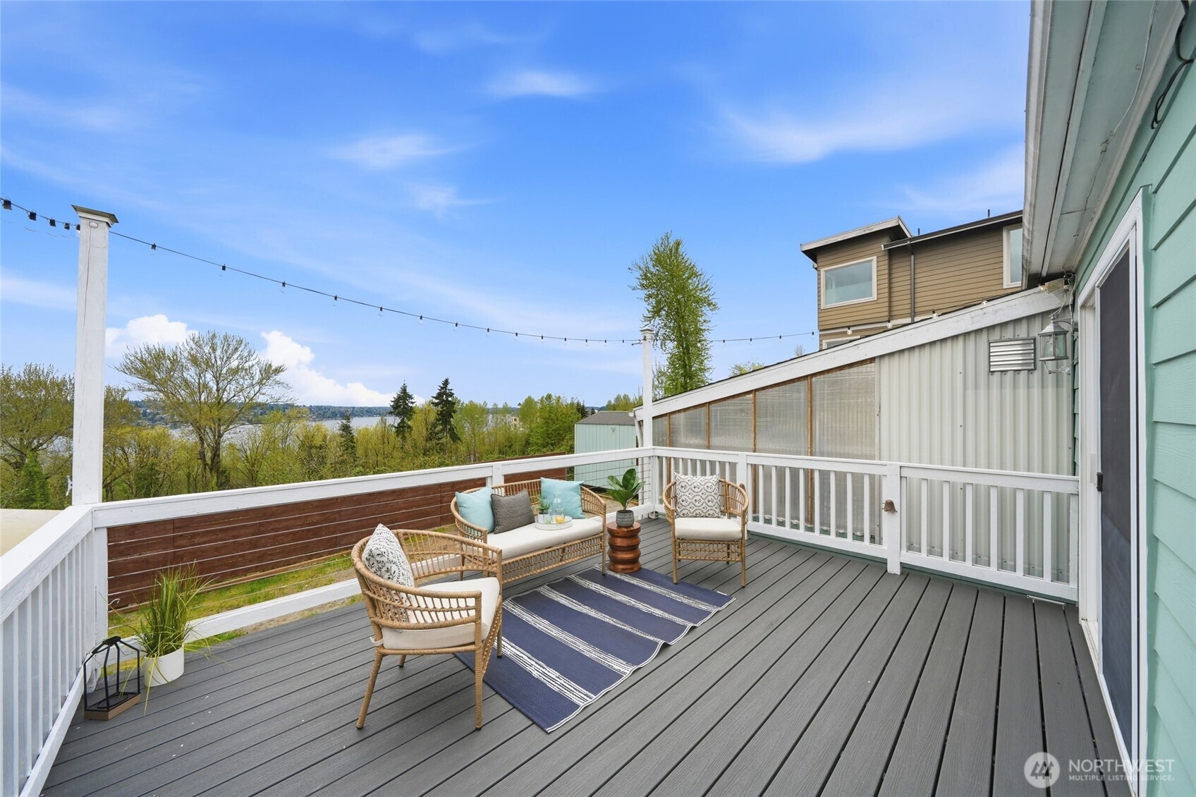 1425 Jones Avenue Northeast Renton, WA 98056 - Photo 4 of 36 a roof deck with table and chairs and wooden floor