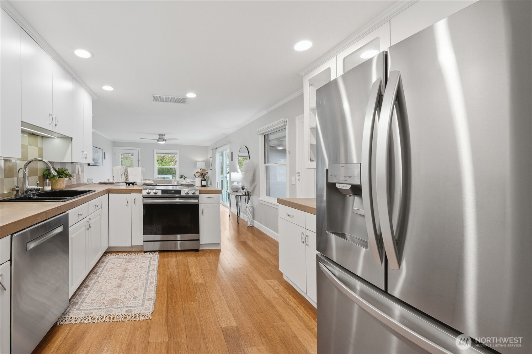 1425 Jones Avenue Northeast Renton, WA 98056 - Photo 8 of 36 a kitchen with stainless steel appliances a refrigerator sink and stove