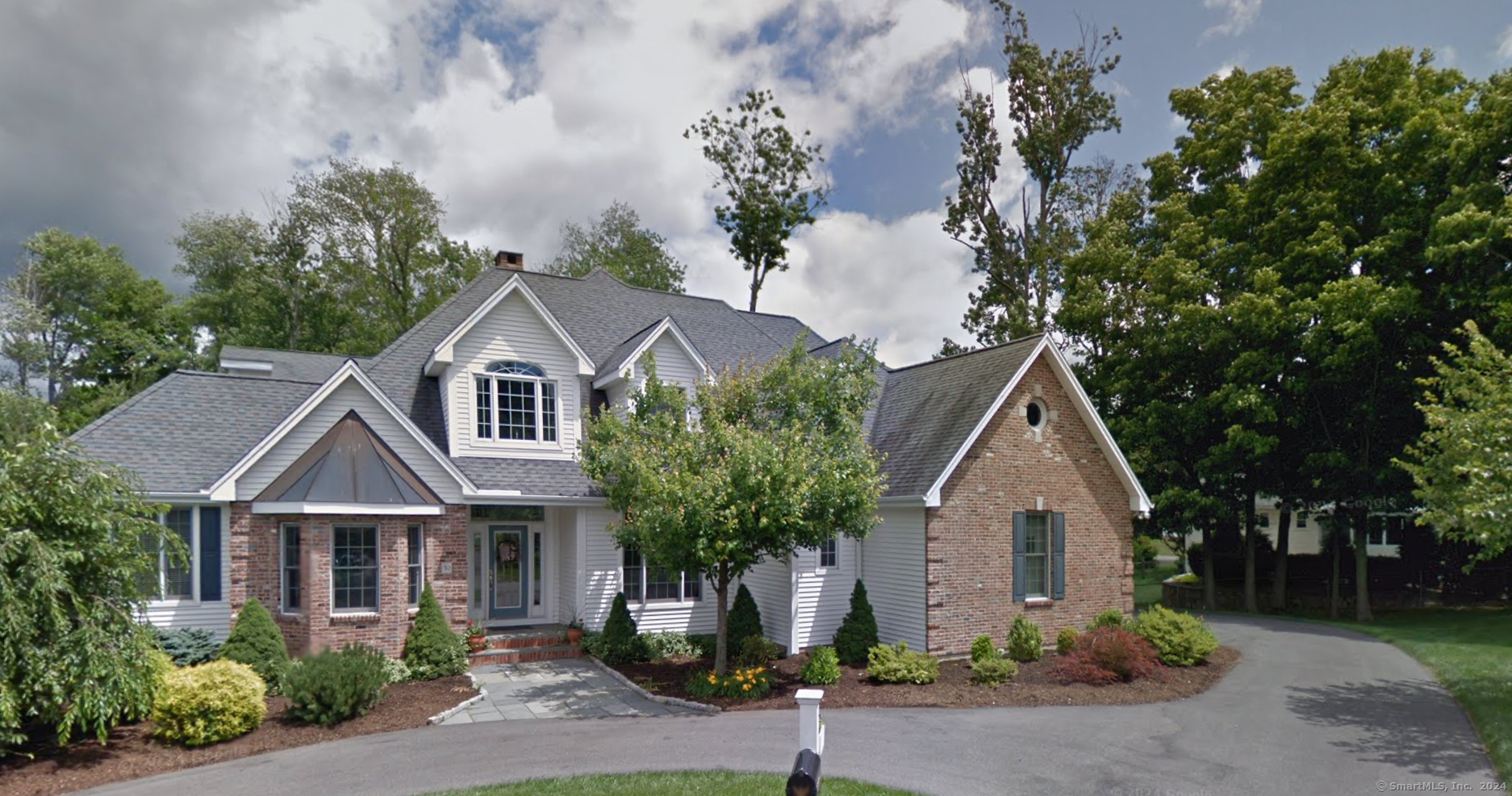 a front view of a house with garden