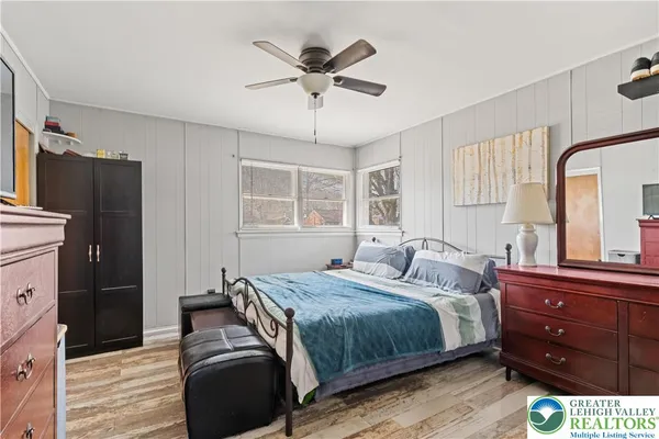 a bedroom with a bed dresser and a window