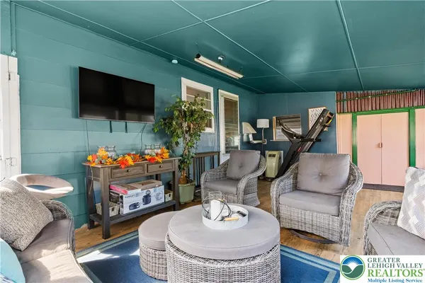 a living room with furniture and a flat screen tv
