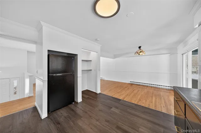 an empty room with a window and a ceiling fan