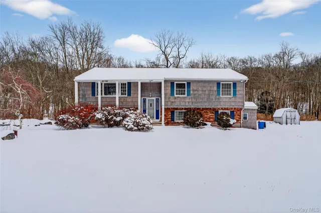 a view of a house with a yard and pathway