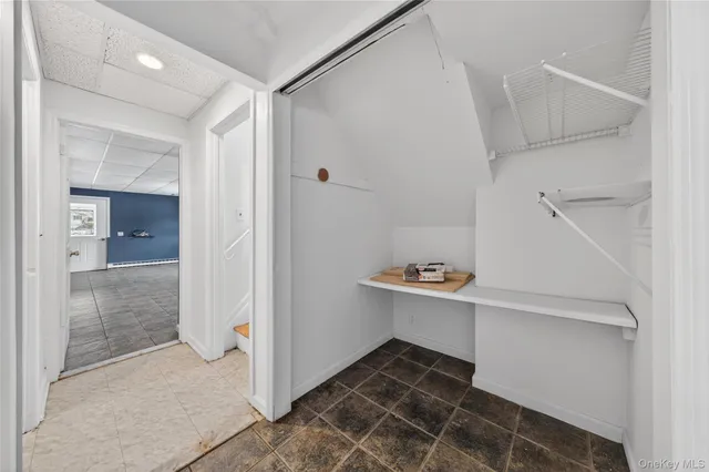 a bathroom with a granite countertop toilet sink and mirror