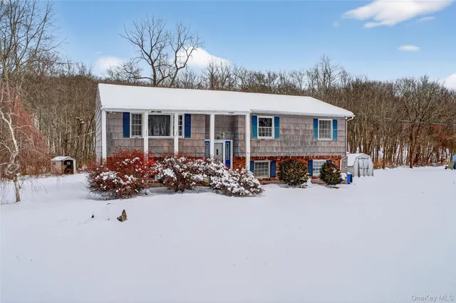 a view of a house with a yard covered in snow