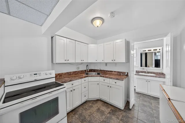 a view of a house with a yard and pathway