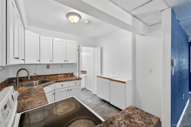 a view of a house with a large window and a yard