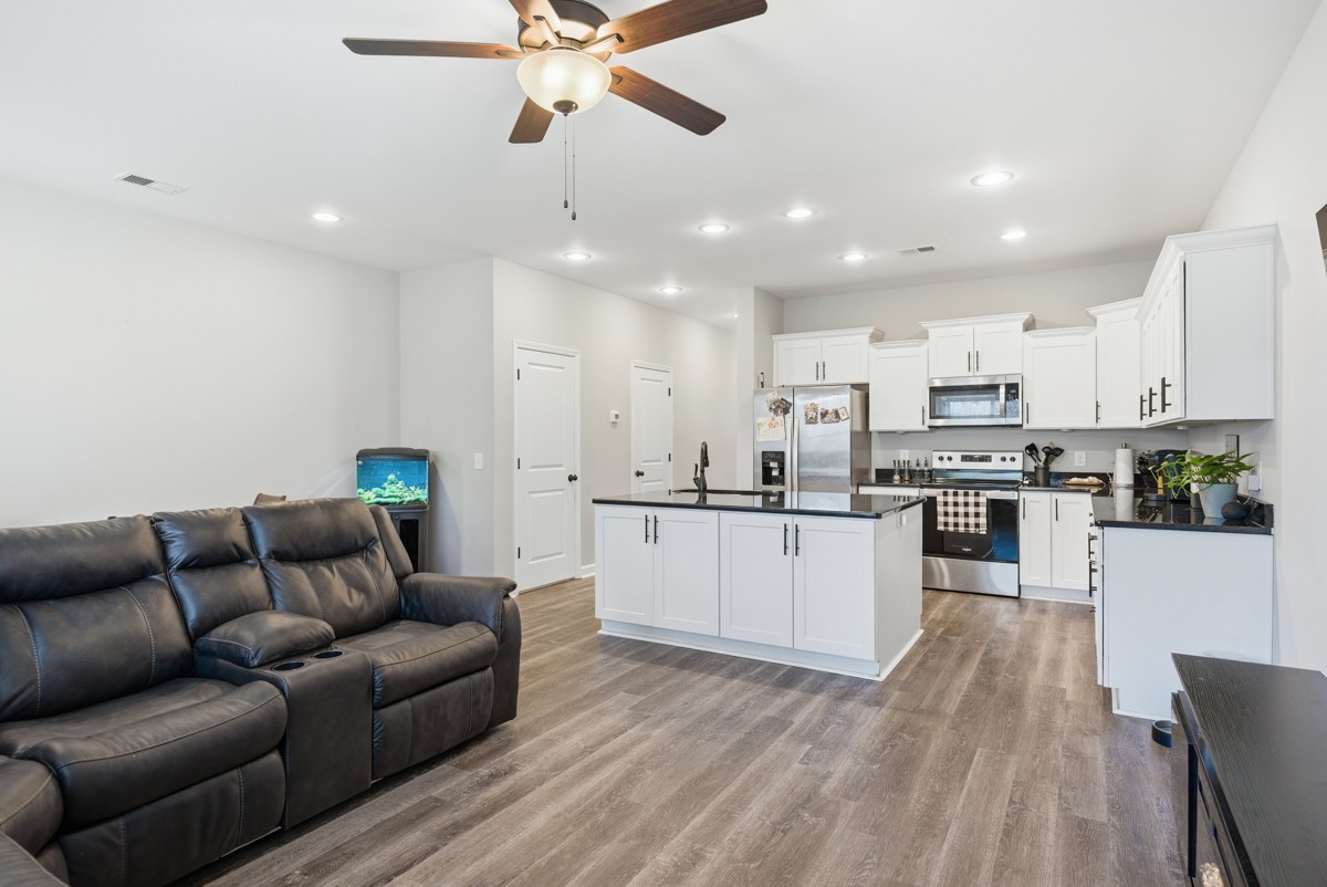 1279 Bluebird Road Lebanon, TN 37087 - Photo 12 of 33 a kitchen with stainless steel appliances granite countertop a refrigerator a oven a sink dishwasher and white cabinets with wooden floor