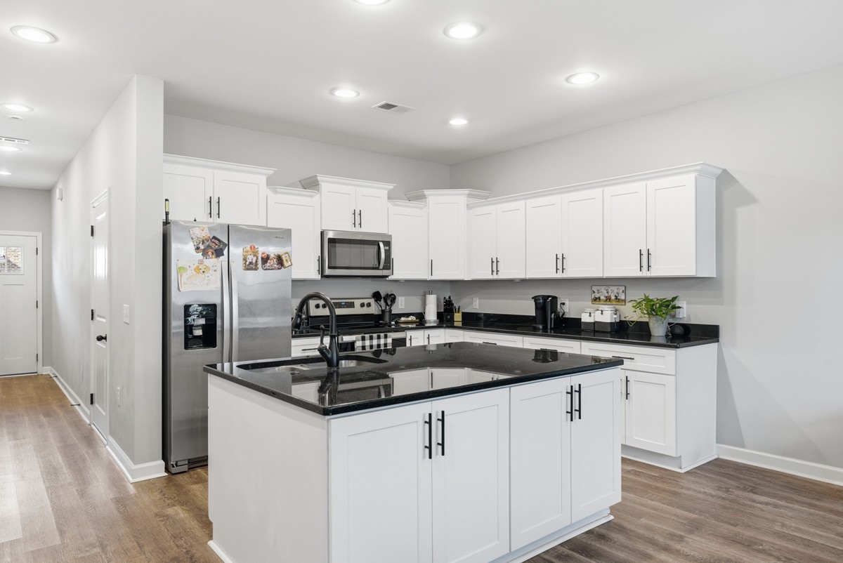 1279 Bluebird Road Lebanon, TN 37087 - Photo 13 of 33 a kitchen with stainless steel appliances granite countertop a sink stove and refrigerator