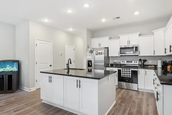 a kitchen with stainless steel appliances granite countertop a sink and cabinets