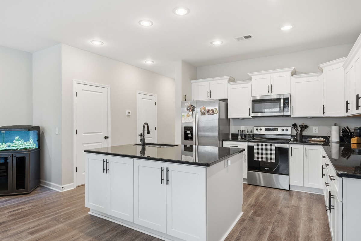 1279 Bluebird Road Lebanon, TN 37087 - Photo 14 of 33 a kitchen with stainless steel appliances granite countertop a sink and cabinets