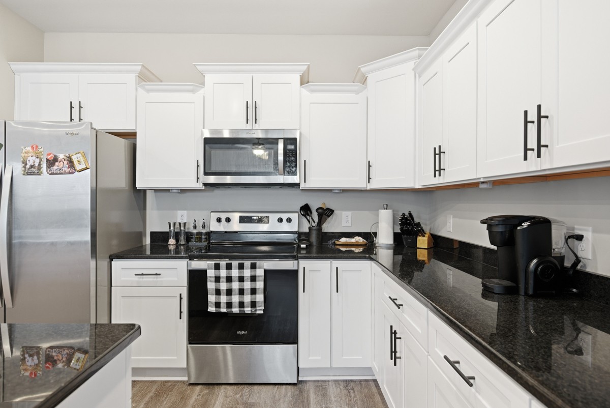 1279 Bluebird Road Lebanon, TN 37087 - Photo 15 of 33 a kitchen with granite countertop a sink a stove and cabinets