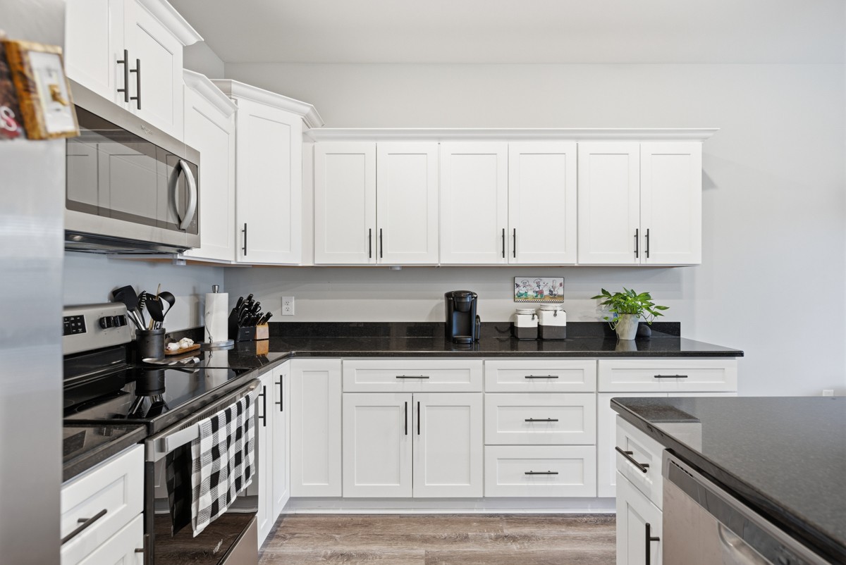 1279 Bluebird Road Lebanon, TN 37087 - Photo 16 of 33 a kitchen with stainless steel appliances granite countertop white cabinets and a stove