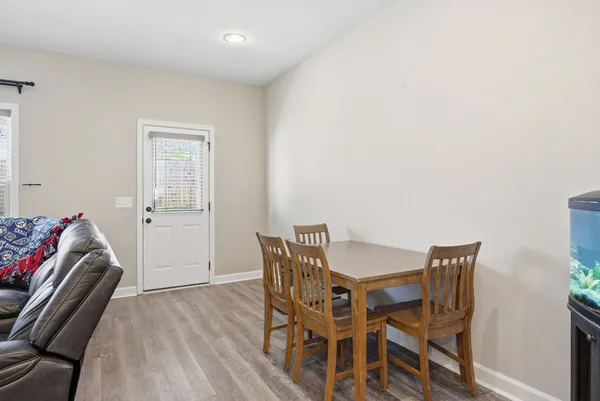a view of a room with furniture and wooden floor