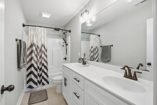 a bathroom with a sink double vanity and shower