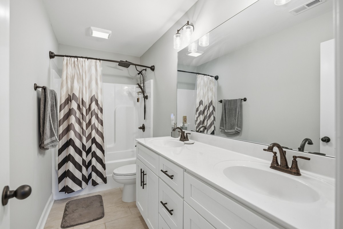 1279 Bluebird Road Lebanon, TN 37087 - Photo 23 of 33 a bathroom with a sink double vanity and shower
